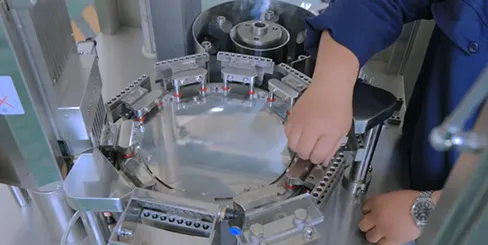 Operator Adjusts Capsule Filling Machine